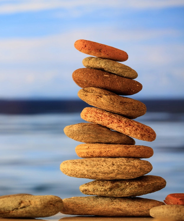 zen-stones-stack-on-blue-sky-and-sea-background-2023-11-27-05-12-23-utc zen-stones-stack-on-blue-sky-and-sea-background-2023-11-27-05-12-23-utc